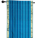 Blue sari rod pocket curtains hung at a window