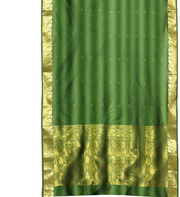 Green sari rod pocket curtains hung at a window