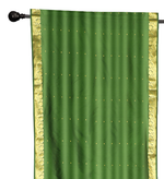 Green sari rod pocket curtains hung at a window