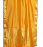 Yellow sari rod pocket curtains hung at a window
