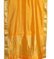 Yellow sari rod pocket curtains hung at a window