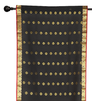 Black sari rod pocket curtains hung at a window