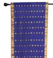 Blue sari rod pocket curtains hung at a window
