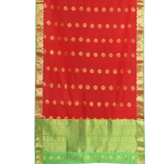Red sari rod pocket curtains hung at a window