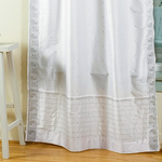Silver sari rod pocket curtains hung at a window