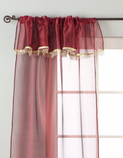 Maroon sheer tissue rod pocket curtains hung at a window