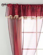 Maroon sheer tissue rod pocket curtains hung at a window
