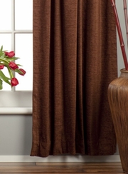 Brown velvet rod pocket curtains hung at a window