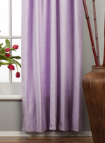 Lavender velvet rod pocket curtains hung at a window