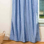 Light blue velvet rod pocket curtains hung at a window