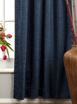Navy blue velvet rod pocket curtains hung at a window
