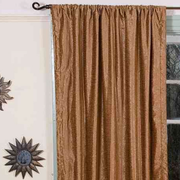 Taupe velvet rod pocket curtains hung at a window