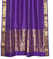 Purple sari ring top curtains hung at a window