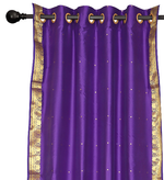 Purple sari ring top curtains hung at a window