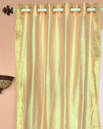 Golden sari grommet top curtains hung at a window