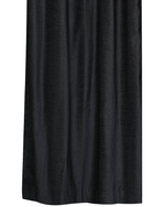 Burgundy velvet ring top curtains hung at a window