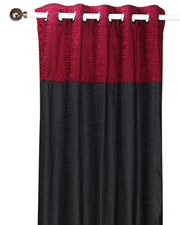 Burgundy velvet ring top curtains hung at a window