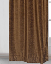 Yellow velvet ring top curtains hung at a window