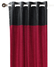 Burgundy velvet ring top curtains hung at a window