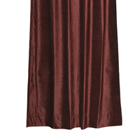 Wine velvet grommet top curtains hung at a window