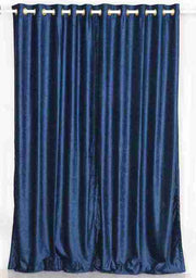 Navy blue velvet grommet top curtains hung at a window