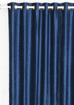 Navy blue velvet grommet top curtains hung at a window