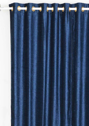 Navy blue velvet grommet top curtains hung at a window