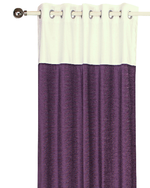 Purple velvet ring top curtains hung at a window