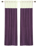 Purple velvet ring top curtains hung at a window