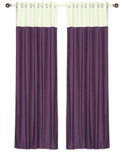 Purple velvet ring top curtains hung at a window