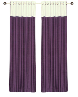 Purple velvet ring top curtains hung at a window