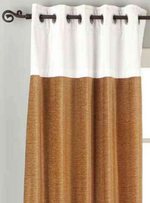 Taupe velvet ring top curtains hung at a window