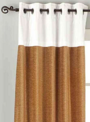 Taupe velvet ring top curtains hung at a window