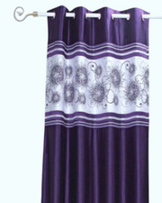 Purple sari grommet top curtains hung at a window