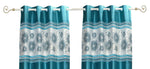 Turquoise sari grommet top curtains hung at a window
