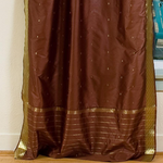 Brown sari tie top curtains hung at a window