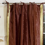 Brown sari tie top curtains hung at a window