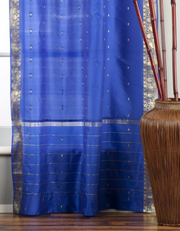 Blue sari tie top curtains hung at a window