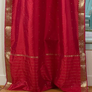 Fire brick sari tie top curtains hung at a window