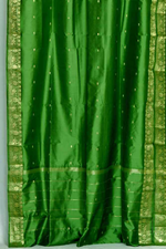 Forest green sari tie top curtains hung at a window