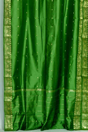 Forest green sari tie top curtains hung at a window