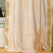 Golden sari tie top curtains hung at a window