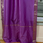 Lavender sari tie top curtains hung at a window