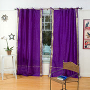 Purple sari tie top curtains hung at a window