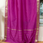 Violet sari tie top curtains hung at a window