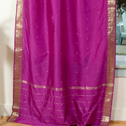 Violet sari tie top curtains hung at a window