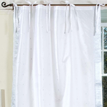 Silver sari tie top curtains hung at a window