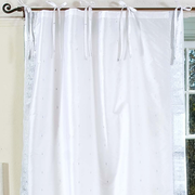 Silver sari tie top curtains hung at a window
