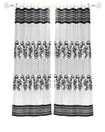 Black sheer tissue ring top curtains hung at a window
