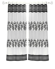 Black sheer tissue ring top curtains hung at a window